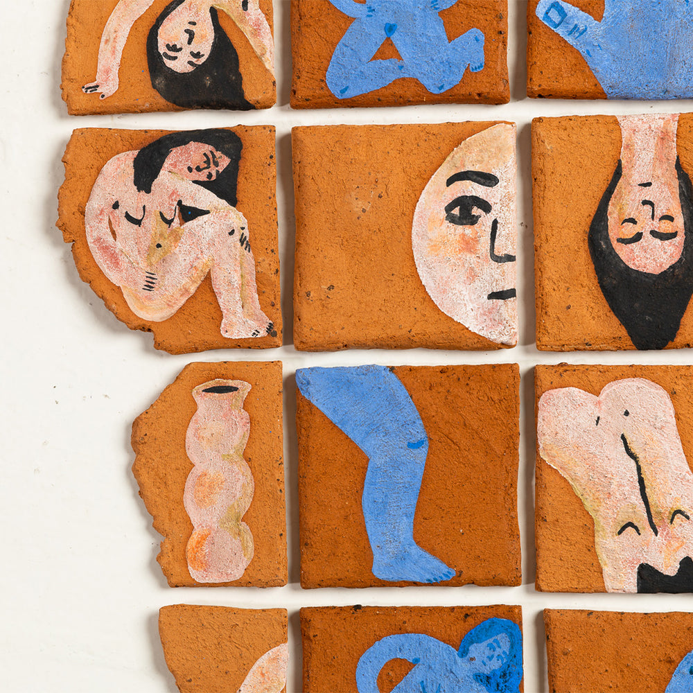 Collection of terracotta tiles with painted figures on a white background