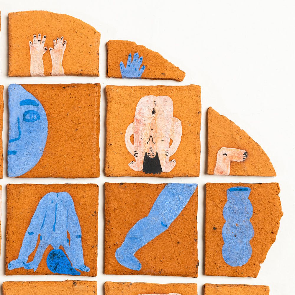 Collection of terracotta tiles with painted figures on a white background